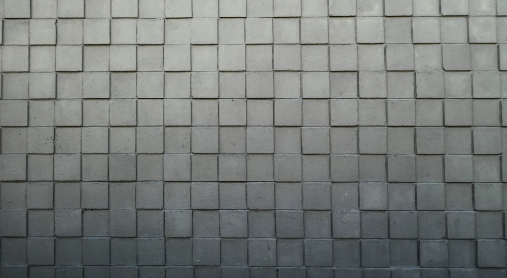 Betonnen muur met vierkante blokken in strak rasterpatroon